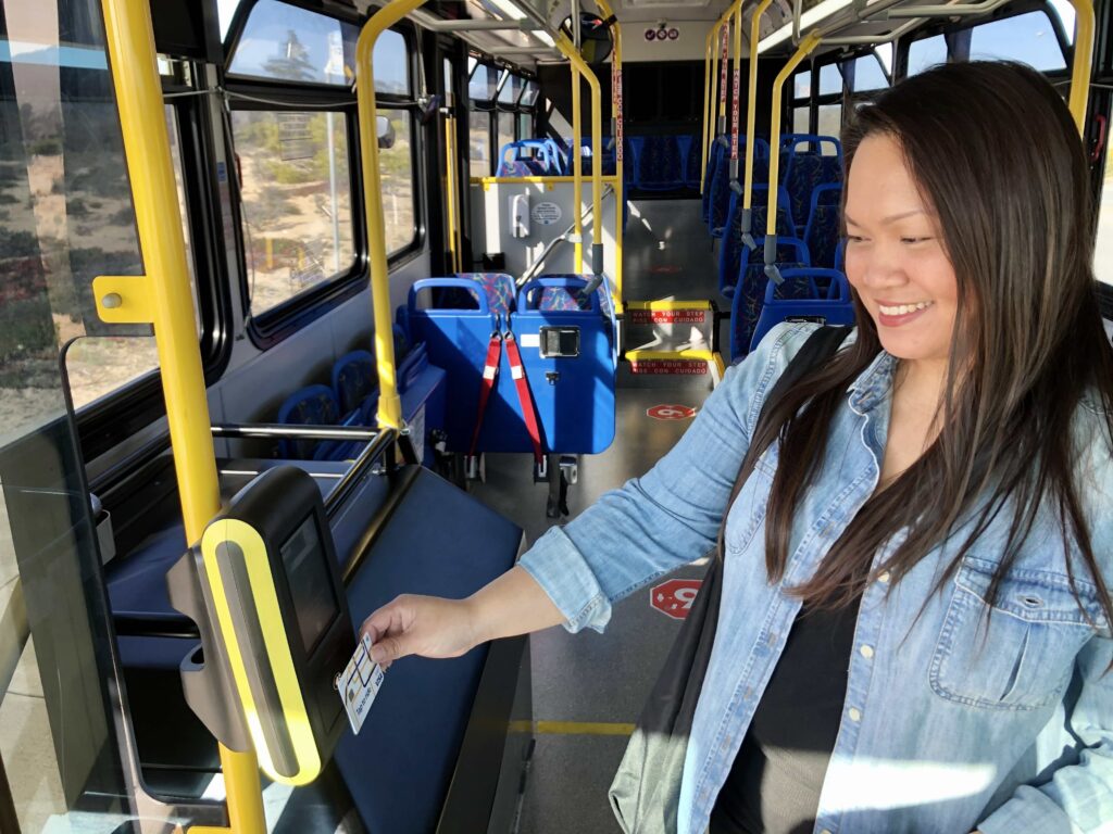 Lady tapping her card on a bus